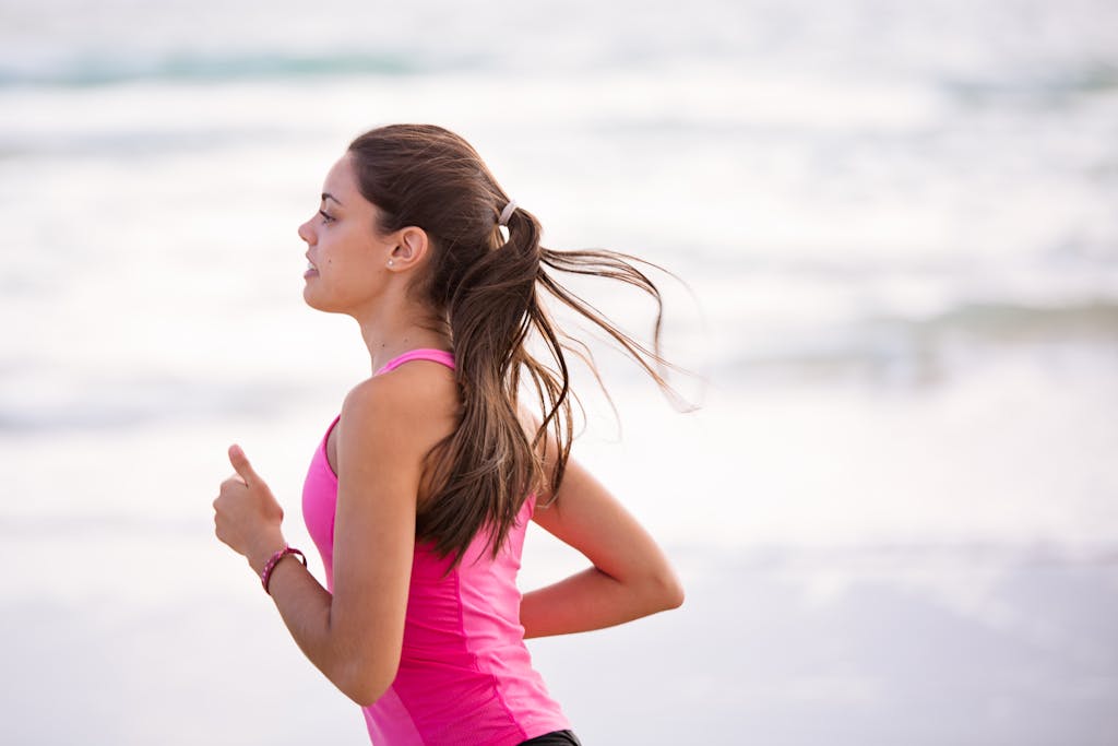 Person jogging outdoors on a sunny day, wearing athletic gear, representing active summer lifestyles and post-workout recovery.