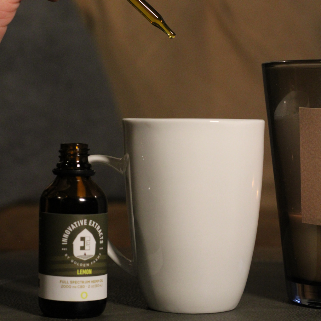 Innovative Extracts CBD oil being dropped into tea
