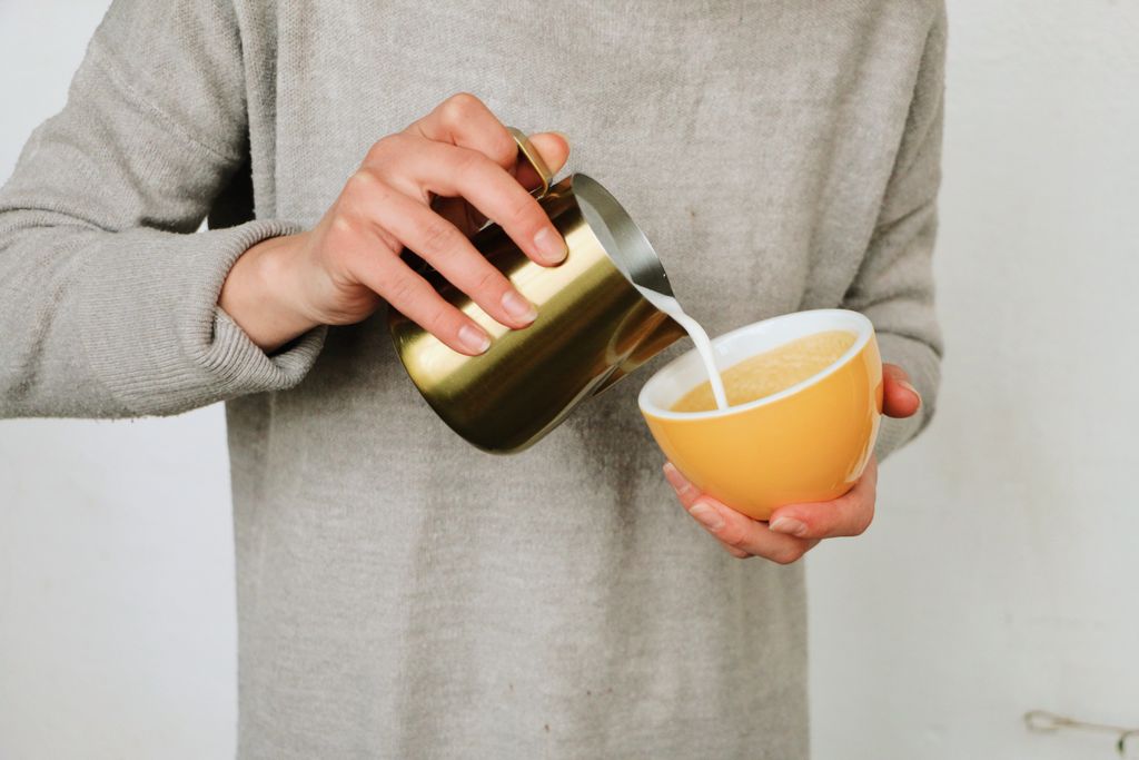 Shaking CBD oil with milk for an iced CBD coffee.